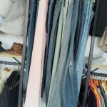 Denim jeans in different washes hanging on a rack