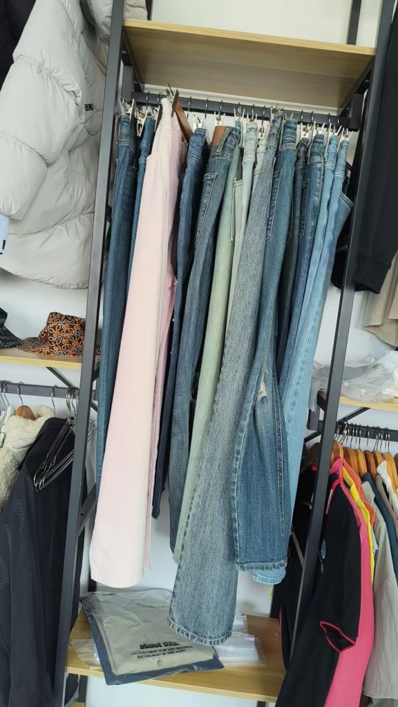 Denim jeans in different washes hanging on a rack