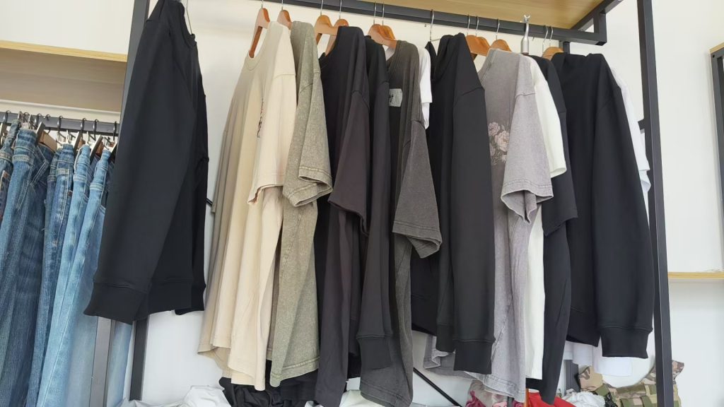 Fleece hoodie and heavyweight knitwear on a garment rack