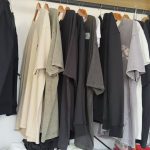 Fleece hoodie and heavyweight knitwear on a garment rack