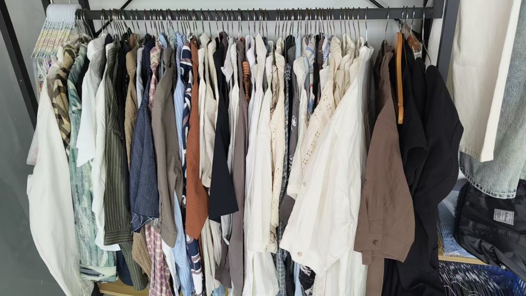 Trousers, chinos and linen pants hanging on a rack