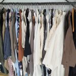 Trousers, chinos and linen pants hanging on a rack