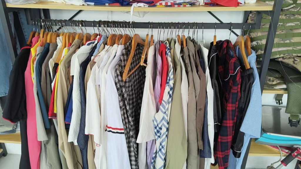 T-shirts, polos and tops on a garment rack at the Lingyu sample room