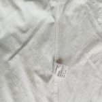 Care label showing 100% cotton composition inside a garment